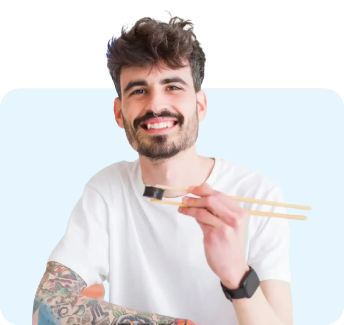 A man eating sushi with chopsticks